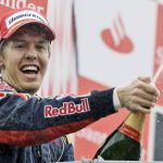 
              FILE - Germany's Sebastian Vettel celebrates on podium after taking his Toro Rosso to victory during the Formula One Grand Prix in Monza, Italy, Sunday, Sept.14, 2008. Four-time Formula One champion Sebastian Vettel says he will retire at the end of the season to spend more time with his family. The German driver won the F1 title from 2010-13 with the Red Bull team. His last race victory came with Ferrari in 2019. He has been largely unsuccessful this season with Aston Martin with a best finish of sixth place. (AP Photo/Alberto Pellaschiar, File)
            