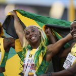 
              Shelly-Ann Fraser-Pryce, of Jamaica, cemter, reacts after winning Gold in the final in the women's 100-meter run at the World Athletics Championships on Sunday, July 17, 2022, in Eugene, Ore. (AP Photo/Ashley Landis)
            
