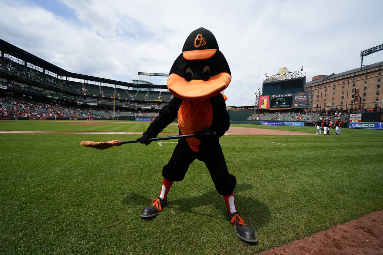 The Oriole Bird holds a broom after the Baltimore Orioles defeating the Los Angeles Angels 9-5 duri...