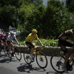 
              Sepp Kuss of the U.S., right, sets the pace for Denmark's Jonas Vingegaard, wearing the overall leader's yellow jersey, as Slovenia's Tadej Pogacar, wearing the best young rider's white jersey, follows as they climb Col d'Aubisque pass during the eighteenth stage of the Tour de France cycling race over 143.5 kilometers (89.2 miles) with start in Lourdes and finish in Hautacam, France, Thursday, July 21, 2022. (AP Photo/Daniel Cole)
            