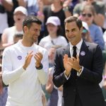 
              Serbia's Novak Djokovic and Switzerland's Roger Federer applaud during a 100 years of Centre Court celebration on day seven of the Wimbledon tennis championships in London, Sunday, July 3, 2022. (AP Photo/Kirsty Wigglesworth)
            