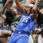 
              Connecticut Sun forward Jonquel Jones (35) collides with Seattle Storm center Tina Charles during the first half of a WNBA basketball game Thursday, July 28, 2022, in Uncasville, Conn. (AP Photo/Bryan Woolston)
            