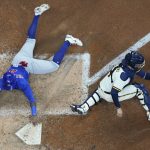 
              Chicago Cubs' Nelson Velazquez slides safely past Milwaukee Brewers catcher Victor Caratini during the sixth inning of a baseball game Tuesday, July 5, 2022, in Milwaukee. Velazquez scored on a hit by Rafael Ortega. (AP Photo/Morry Gash)
            