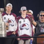 
              With the Stanley Cup on display, Colorado Avalanche head coach Jared Bednar, front right, speaks during a rally outside the City/County Building for the NHL hockey champions after a parade through the streets of downtown Denver, Thursday, June 30, 2022. Looking on are defensemen Erik Johnson, back left, and Bowen Byram. (AP Photo/David Zalubowski)
            