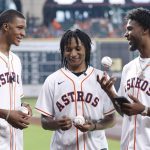 
              Houston Rockets draft picks Jabari Smith, TyTy Washington and Tari Eason talk before throwing out ceremonial first pitches before a baseball game between the Houston Astros and the Kansas City Royals on Tuesday, July 5, 2022, in Houston. (AP Photo/Kevin M. Cox)
            