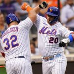 
              New York Mets' Pete Alonso (20) celebrates with Daniel Vogelbach (32) after hitting a home run against the New York Yankees during the second inning of a baseball game Wednesday, July 27, 2022, in New York. (AP Photo/Frank Franklin II)
            