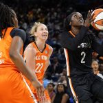 
              Team Stewart's Kahleah Copper, right, drives to the basket past Team Wilson's Ariel Atkins, left, and Courtney Vandersloot during the first half of a WNBA All-Star basketball game in Chicago, Sunday, July 10, 2022. (AP Photo/Nam Y. Huh)
            