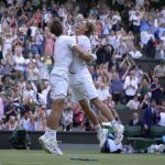 
              Matthew Ebden, left, and Max Purcell of Australia celebrate after beating Mate Pavic and Nikola Mektic of Croatia to win the final of the men's doubles on day thirteen of the Wimbledon tennis championships in London, Saturday, July 9, 2022. (AP Photo/Kirsty Wigglesworth)
            
