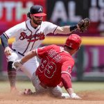 
              Los Angeles Angels' Max Stassi (33) beats the tag from Atlanta Braves shortstop Dansby Swanson, left, as he slides into second base during the third inning of a baseball game, Sunday, July 24, 2022, in Atlanta. (AP Photo/Butch Dill)
            