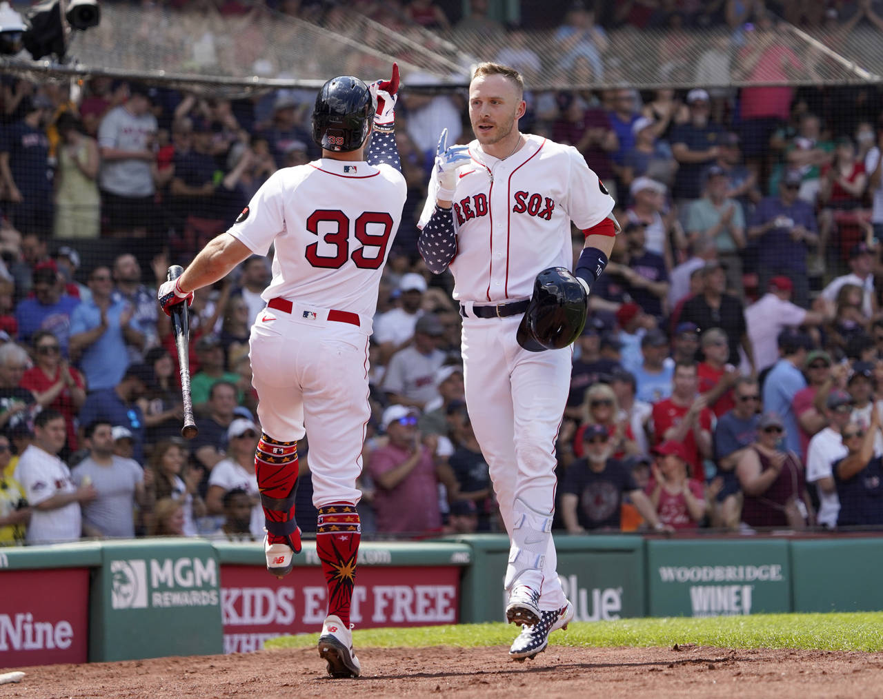 Boston Red Sox's Trevor Story, right, is congratulated by Christian Arroyo (39) after hitting a sol...