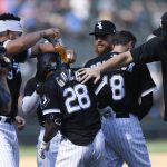 
              Chicago White Sox's Leury Garcia (28) is congratulated by teammates after he drove in the winning run in the 10th inning against the Minnesota Twins in a baseball game Wednesday, July 6, 2022, in Chicago. (AP Photo/Paul Beaty)
            