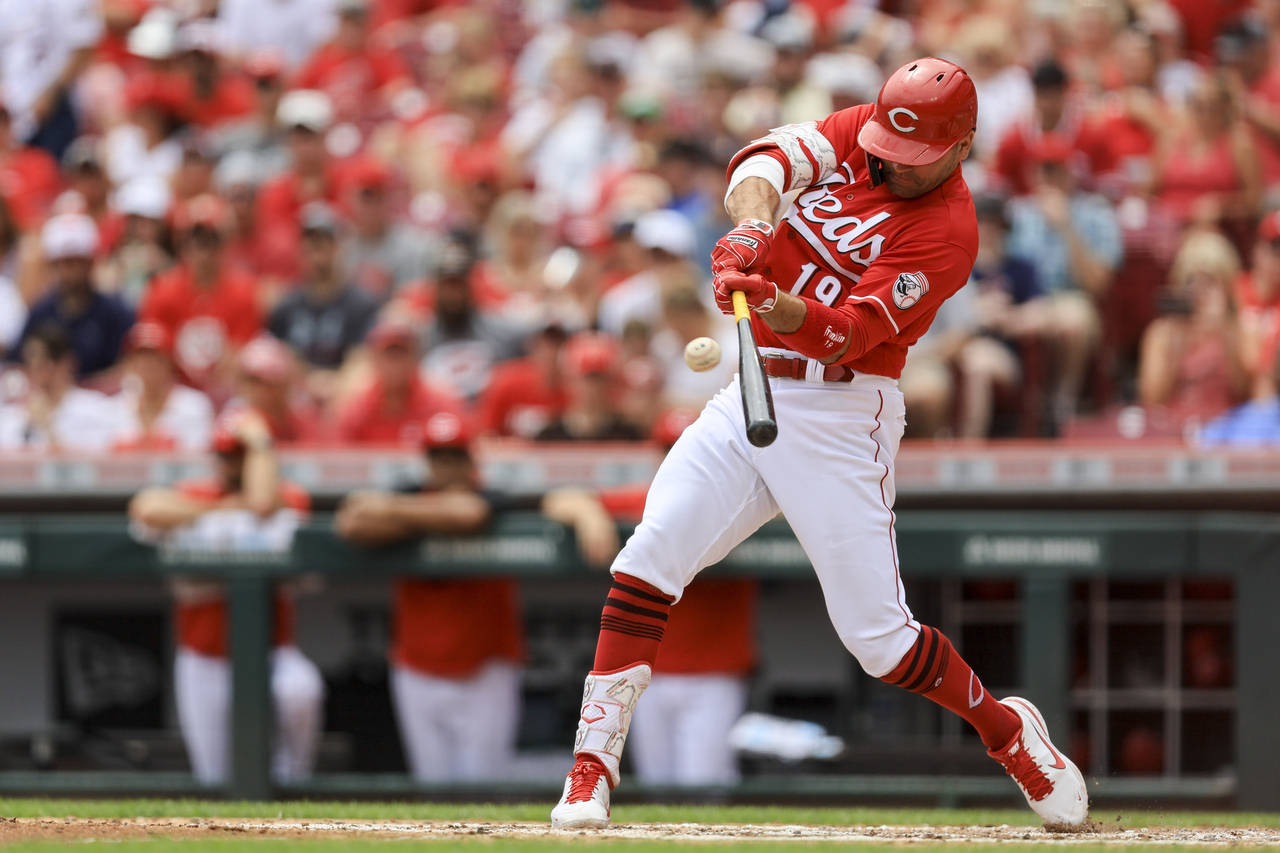 Cincinnati Reds' Joey Votto hits a three-run home run during the third inning of a baseball game ag...