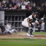 
              Detroit Tigers' Jonathan Schoop scores on a Jeimer Candelario single while while Chicago White Sox catcher Seby Zavala waits for the throw during the sixth inning of a baseball game Friday, July 8, 2022, in Chicago. (AP Photo/Paul Beaty)
            
