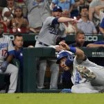 
              Los Angeles Dodgers' Austin Barnes falls rounding third during the ninth inning of a baseball game against the St. Louis Cardinals Wednesday, July 13, 2022, in St. Louis. (AP Photo/Jeff Roberson)
            