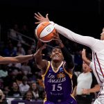 
              Los Angeles Sparks Brittney Sykes (15) drives between Washington Mystics guard Shatori Walker-Kimbrough (32) and forward Alysha Clark (22) during the first half of a WNBA basketball game Tuesday, July 12, 2022, in Los Angeles. (Keith Birmingham/The Orange County Register via AP)
            