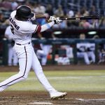 
              Arizona Diamondbacks' Geraldo Perdomo connects for a run-scoring double against the San Francisco Giants during the fifth inning of a baseball game Monday, July 25, 2022, in Phoenix. (AP Photo/Ross D. Franklin)
            