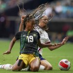 
              Jamaica's Tiernny Wiltshire (19) and United States' Sophia Smith fight for the ball during a CONCACAF Women's Championship soccer match in Monterrey, Mexico, Thursday, July 7, 2022. (AP Photo/Fernando Llano)
            
