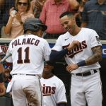 
              Minnesota Twins' Jorge Polanco (11) celebrates with Carlos Correa after hitting a three-run home run against Chicago White Sox pitcher Lance Lynn during the third inning of a baseball game, Saturday, July 16, 2022, in Minneapolis. Max Kepler and Bryon Buxton scored. (AP Photo/Craig Lassig)
            