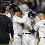 
              New York Yankees' DJ LeMahieu (26) celebrates with teammates after scoring the game-winning run on a wild pitch during the 10th inning of the team's baseball game against the Cincinnati Reds on Wednesday, July 13, 2022, in New York. The Yankees won 7-6. (AP Photo/Frank Franklin II)
            