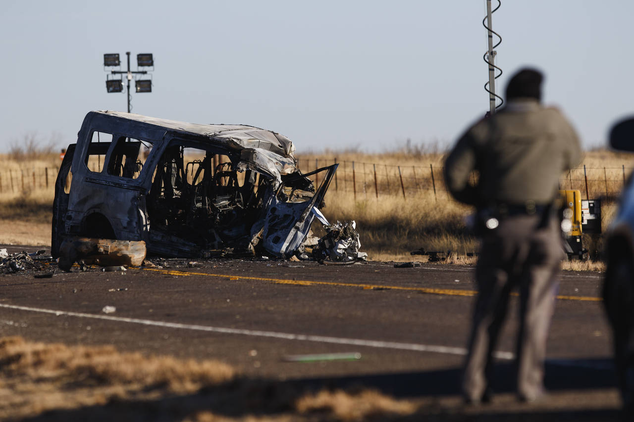 FILE - Texas Department of Public Safety Troopers look over the scene of a fatal car wreck early on...