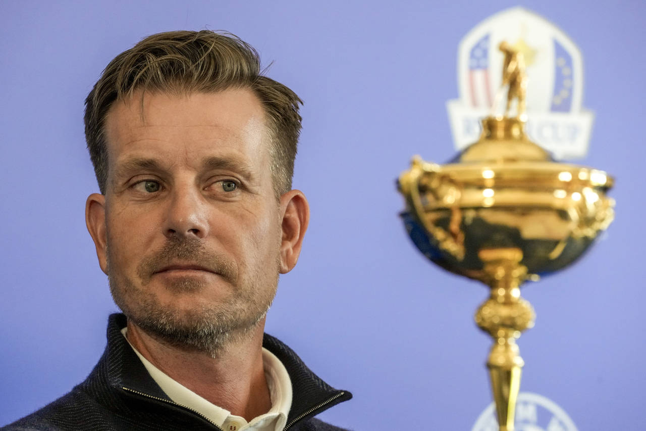 FILE - Henrik Stenson looks at the Ryder Cup Trophy during a press conference, at the Marco Simone ...