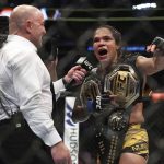 
              Joe Rogan interviews Amanda Nunes after her victory over Julianna Pena in a mixed martial arts women's bantamweight title bout at UFC 277 on Saturday, July 30, 2022, in Dallas. (AP Photo/Richard W. Rodriguez)
            