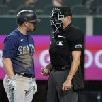 
              Seattle Mariners' Ty France, left, argues with umpire Andy Fletcher after being called out on strikes leaving the bases loaded in the fourth inning of a baseball game against the Texas Rangers, Saturday, July 16, 2022, in Arlington, Texas. (AP Photo/Tony Gutierrez)
            