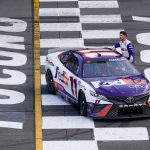 
              ADDS THAT HAMLIN WAS LATER DISQUALIFIED - Denny Hamlin (11) gets out of his car after winning a NASCAR Cup Series auto race at Pocono Raceway, Sunday, July 24, 2022, in Long Pond, Pa. NASCAR stripped Hamlin of his win when his No. 11 Toyota failed inspection and was disqualified, awarding Chase Elliott the Cup Series victory. (AP Photo/Matt Slocum)
            