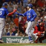 
              Toronto Blue Jays' Danny Jansen, center, celebrates after driving in Santiago Espinal, left, with a home run against the Boston Red Sox during the sixth inning of a baseball game Friday, July 22, 2022, in Boston. (AP Photo/Michael Dwyer)
            