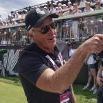 
              LIV CEO Greg Norman talks with fans at the first tee during the final round of the Bedminster Invitational LIV Golf tournament in Bedminster, N.J., Sunday, July 31, 2022. (AP Photo/Seth Wenig)
            
