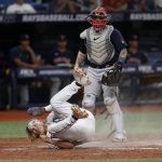 
              Tampa Bay Rays' Taylor Walls slides past Boston Red Sox catcher Christian Vazquez to score during the sixth inning of a baseball game, Monday, July 11, 2022, in St. Petersburg, Fla. (AP Photo/Scott Audette)
            