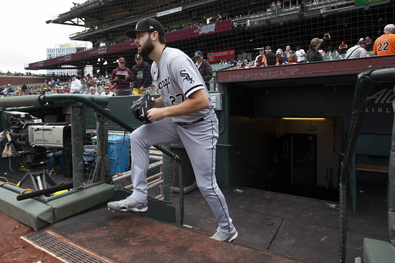Chicago White Sox starting pitcher Lucas Giolito takes the field to warm up before of a baseball ga...