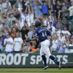
              Seattle Mariners' Julio Rodriguez reacts as he rounds the bases after hitting a solo home run against the Texas Rangers during the first inning of a baseball game, Tuesday, July 26, 2022, in Seattle. (AP Photo/Ted S. Warren)
            