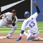 
              Lourdes Gurriel Jr., right, is put out at second base on an attempted steal by Detroit Tigers second baseman Jonathan Schoop in the first inning of a baseball game in Toronto, Saturday, July 30, 2022. (Jon Blacker/The Canadian Press via AP)
            