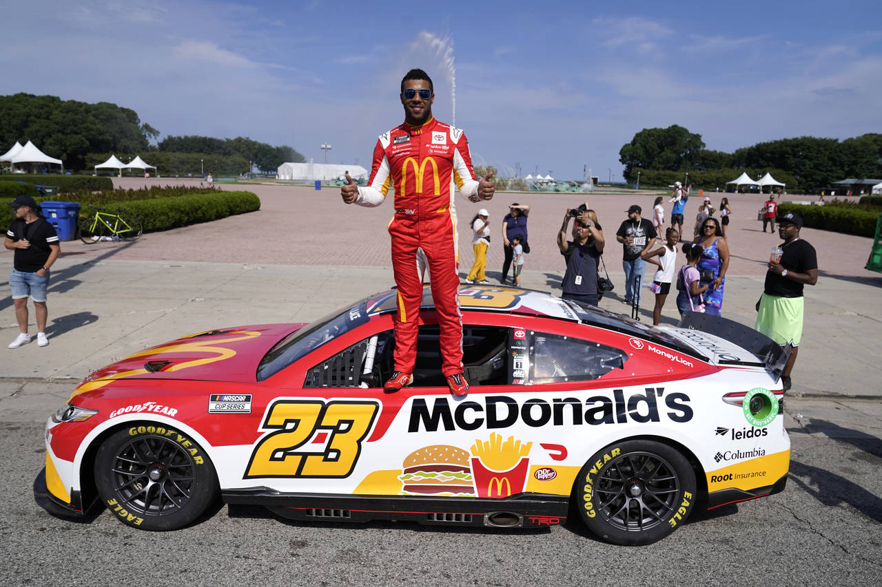 NASCAR driver Bubba Wallace poses for photographers near Buckingham Fountain on Tuesday, July 19, 2...