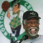 
              FILE - Boston Celtics legendary center Bill Russell has a light moment while answering questions from members of the media after a Celtics team practice in Waltham, Mass., Oct. 11, 1999. The NBA great Bill Russell has died at age 88. His family said on social media that Russell died on Sunday, July 31, 2022. Russell anchored a Boston Celtics dynasty that won 11 titles in 13 years. (AP Photo/Angela Rowlings)
            