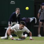
              Serbia's Novak Djokovic falls while attempting to return the ball to Tim van Rijthoven of the Netherlands during a men's fourth round singles match on day seven of the Wimbledon tennis championships in London, Sunday, July 3, 2022.(AP Photo/Kirsty Wigglesworth)
            