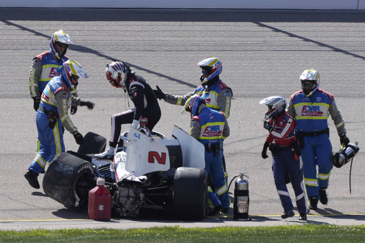 Josef Newgardenk, third from left, climbs out of his car after hitting a wall during an IndyCar Ser...
