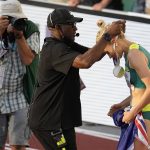 
              Wilbert Greaves gives Gold medalist Eleanor Patterson, of Australia, her Gold medal after winning the women's high jump final the World Athletics Championships on Tuesday, July 19, 2022, in Eugene, Ore.(AP Photo/Gregory Bull)
            