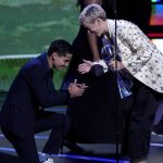 
              Boxer Ryan Garcia, left, kneels before NWSL player Megan Rapinoe, of OL Reign, as she accepts the award for best play at the ESPY Awards on Wednesday, July 20, 2022, at the Dolby Theatre in Los Angeles. (AP Photo/Mark Terrill)
            