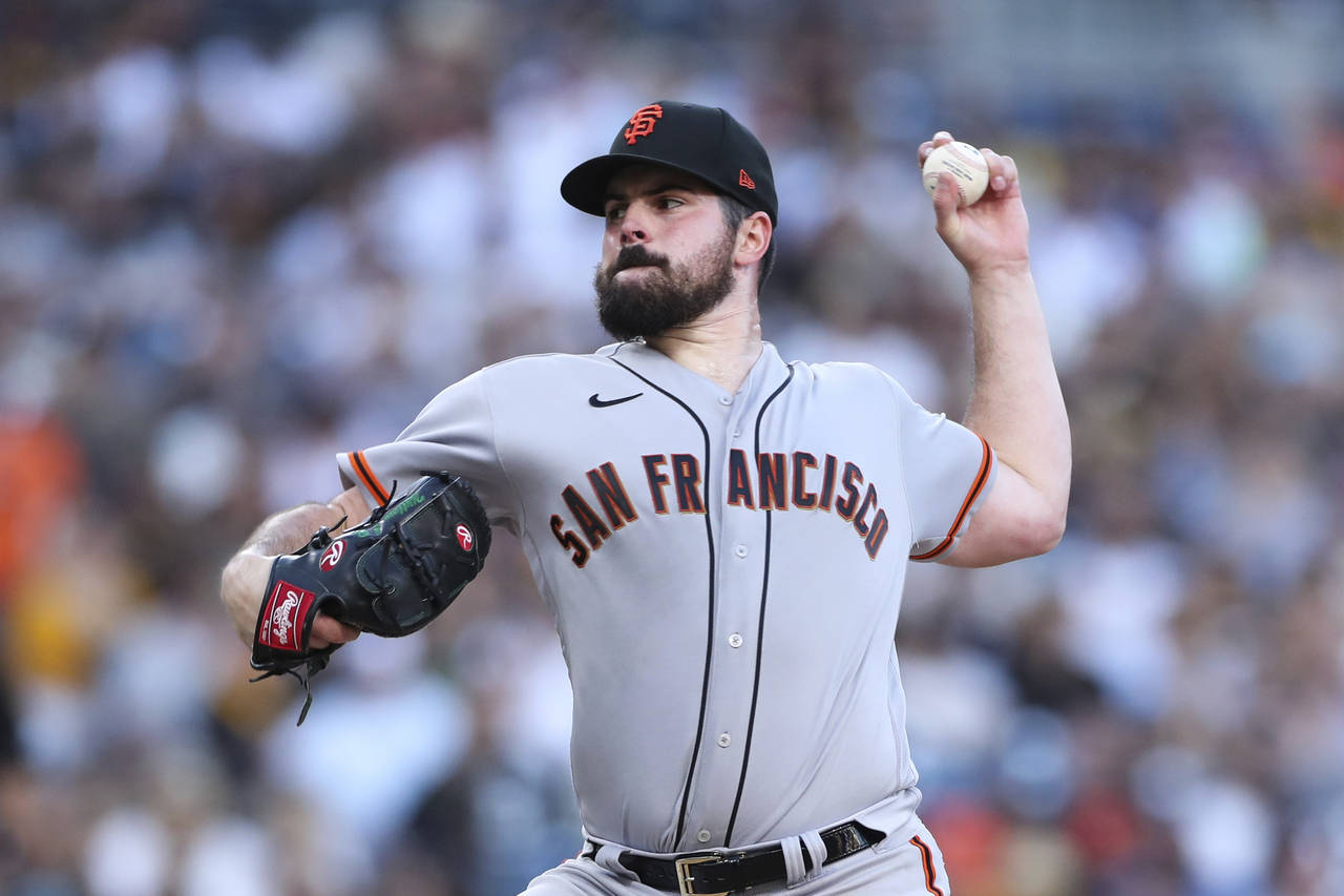 San Francisco Giants starting pitcher Carlos Rodon delivers to a San Diego Padres batter in the nin...