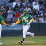 
              Oakland Athletics' Ramón Laureano (22) celebrates with third base coach Darren Bush (51) after hitting a solo home run against the Texas Rangers during the fifth inning of a baseball game in Oakland, Calif., Friday, July 22, 2022. (AP Photo/Godofredo A. Vásquez)
            