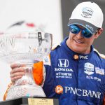 
              Scott Dixon, of New Zealand,  looks at his trophy after winning  an IndyCar auto race in Toronto, Sunday, July 17, 2022. (Andrew Lahodynskyj/The Canadian Press via AP)
            