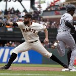 
              Chicago White Sox's Tim Anderson (7) beats out an infield single as San Francisco Giants first baseman Brandon Belt (9) takes the late relay during the fourth inning of a baseball game, Saturday, July 2, 2022, in San Francisco. (AP Photo/D. Ross Cameron)
            