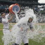 
              Seattle Mariners' Abraham Toro, right, has water dumped onto him by Adam Frazier, left, after Toro hit a single to score Marcus Wilson with the winning run during the ninth inning of the team's baseball game against the Oakland Athletics, Saturday, July 2, 2022, in Seattle. The Mariners won 2-1. (AP Photo/Ted S. Warren)
            