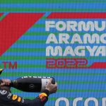 
              Red Bull driver Max Verstappen of the Netherlands drinks champagne on the podium after winning the Hungarian Formula One Grand Prix at the Hungaroring racetrack in Mogyorod, near Budapest, Hungary, Sunday, July 31, 2022. (AP Photo/Darko Bandic)
            