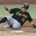 
              Pittsburgh Pirates' Yoshi Tsutsugo of Japan, slides into home plate to score on a fielding error by Miami Marlins third baseman Brian Anderson during the eighth inning of a baseball game, Thursday, July 14, 2022, in Miami. (AP Photo/Wilfredo Lee)
            