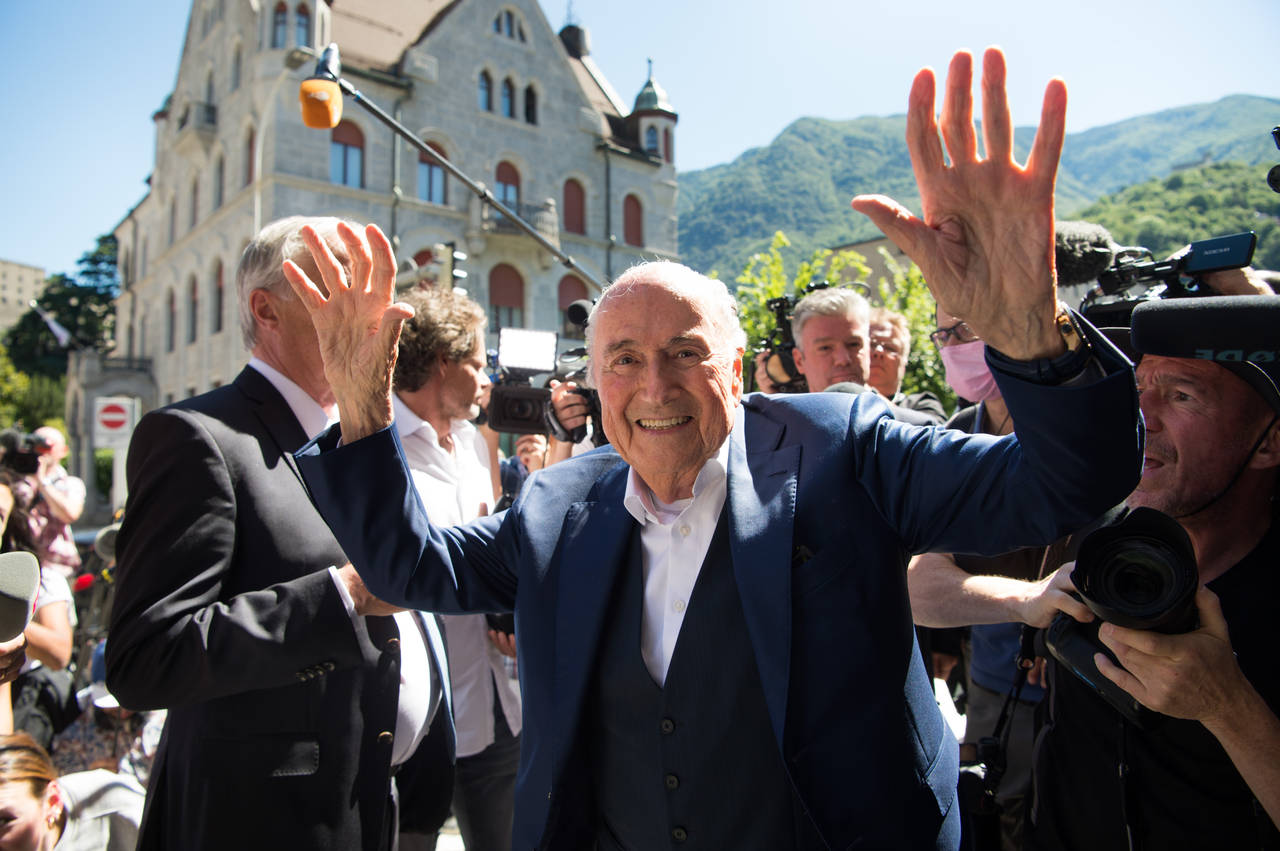The former Fifa President, Joseph Blatter, center, surrounded by media representatives, waves to th...