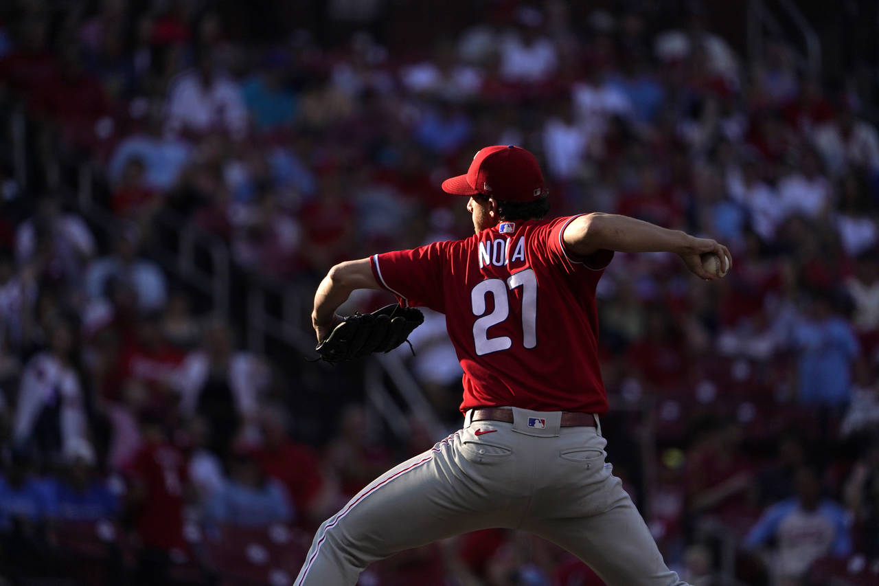 Philadelphia Phillies starting pitcher Aaron Nola throws during the first inning of a baseball game...