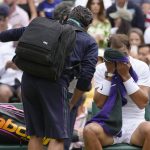 
              Spain's Rafael Nadal receives treatment in a change of ends break as he plays Taylor Fritz of the US in a men's singles quarterfinal match on day ten of the Wimbledon tennis championships in London, Wednesday, July 6, 2022. (AP Photo/Kirsty Wigglesworth)
            